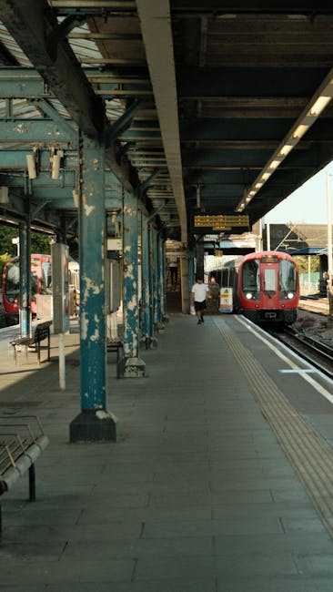 View of Stamford Hill station platform seen through a rounded window in a train, featuring a clean, polished concrete floor, wooden-paneled walls with a warm tone, and a modern ceiling with integrated